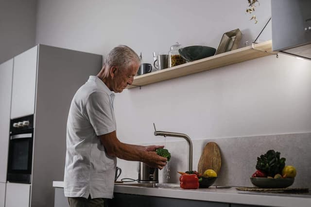 Man washing vegetables